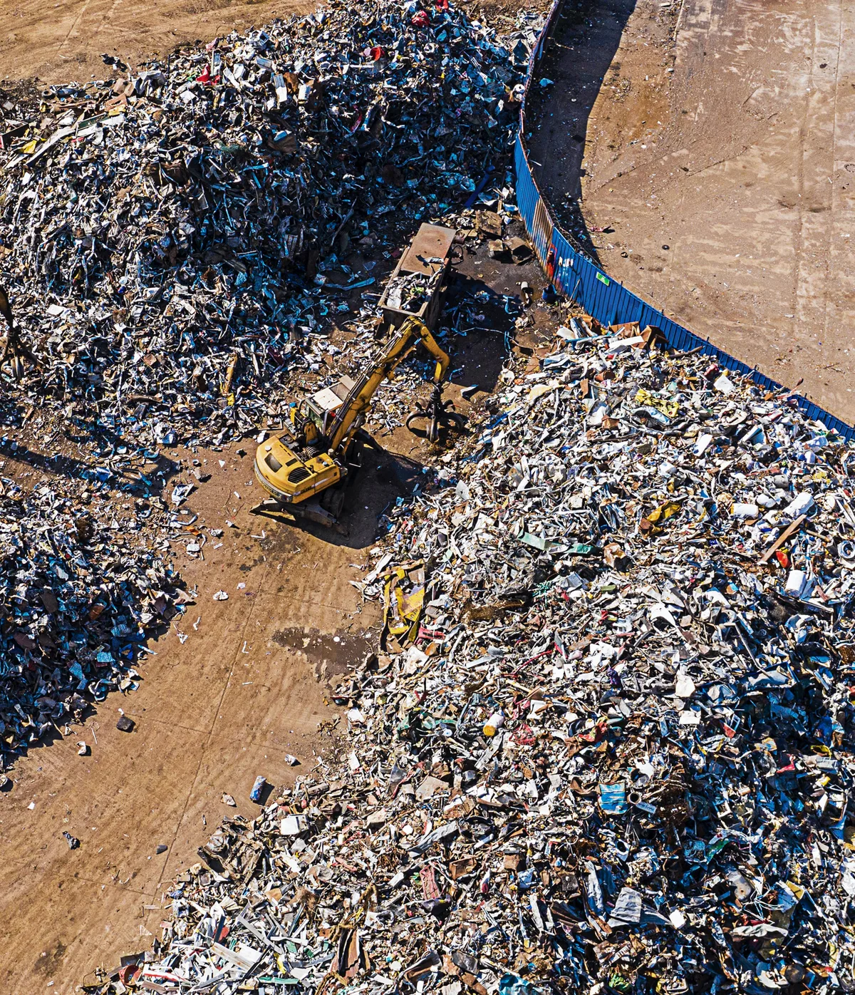 UK industrial WEEE scrap metal processing yard with heavy machinery representing circular economy